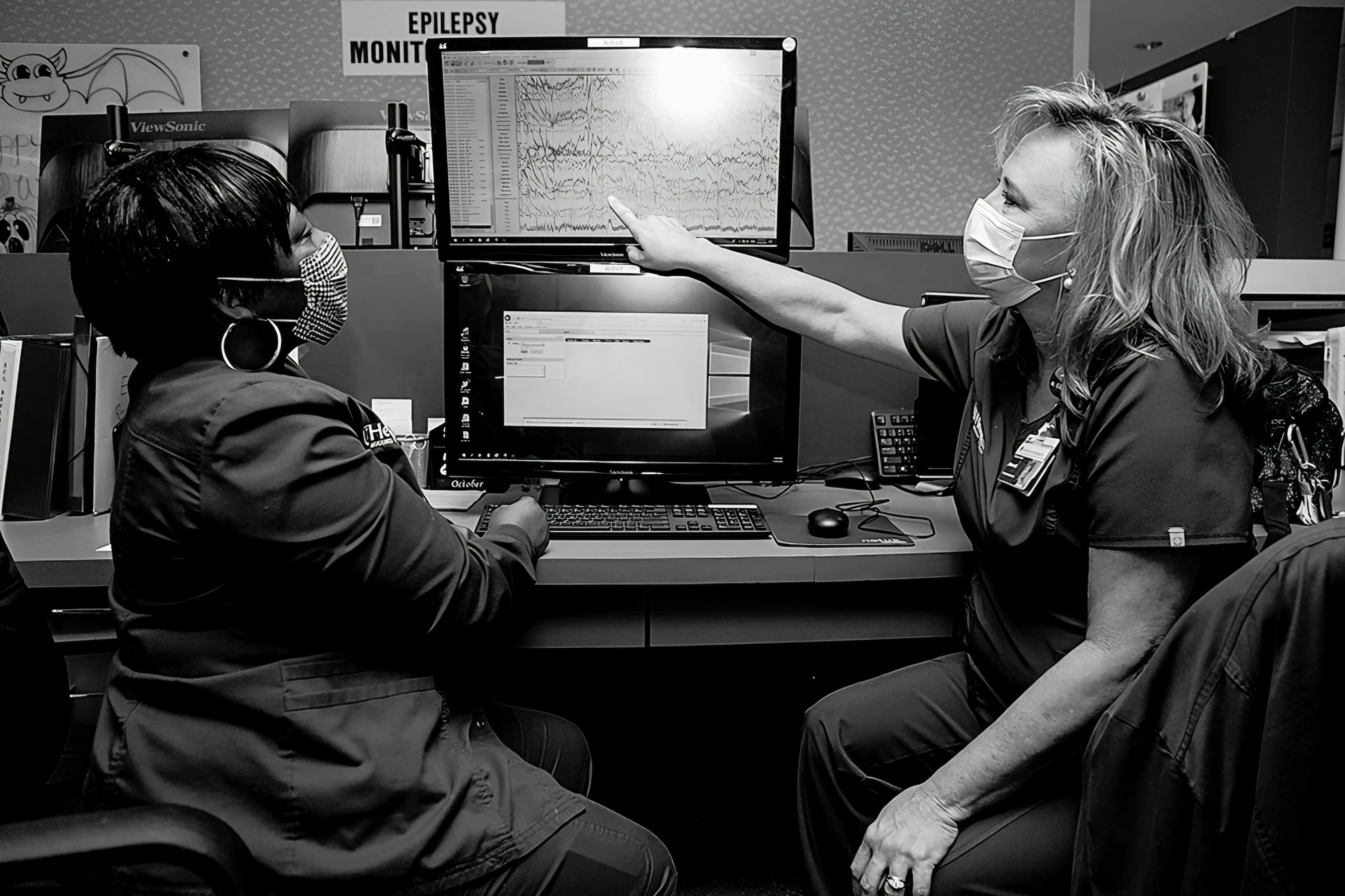 Medical professionals analyzing EEG monitoring data
